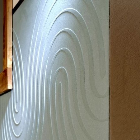 Detailaufnahme von wellenförmigen Lehmputz